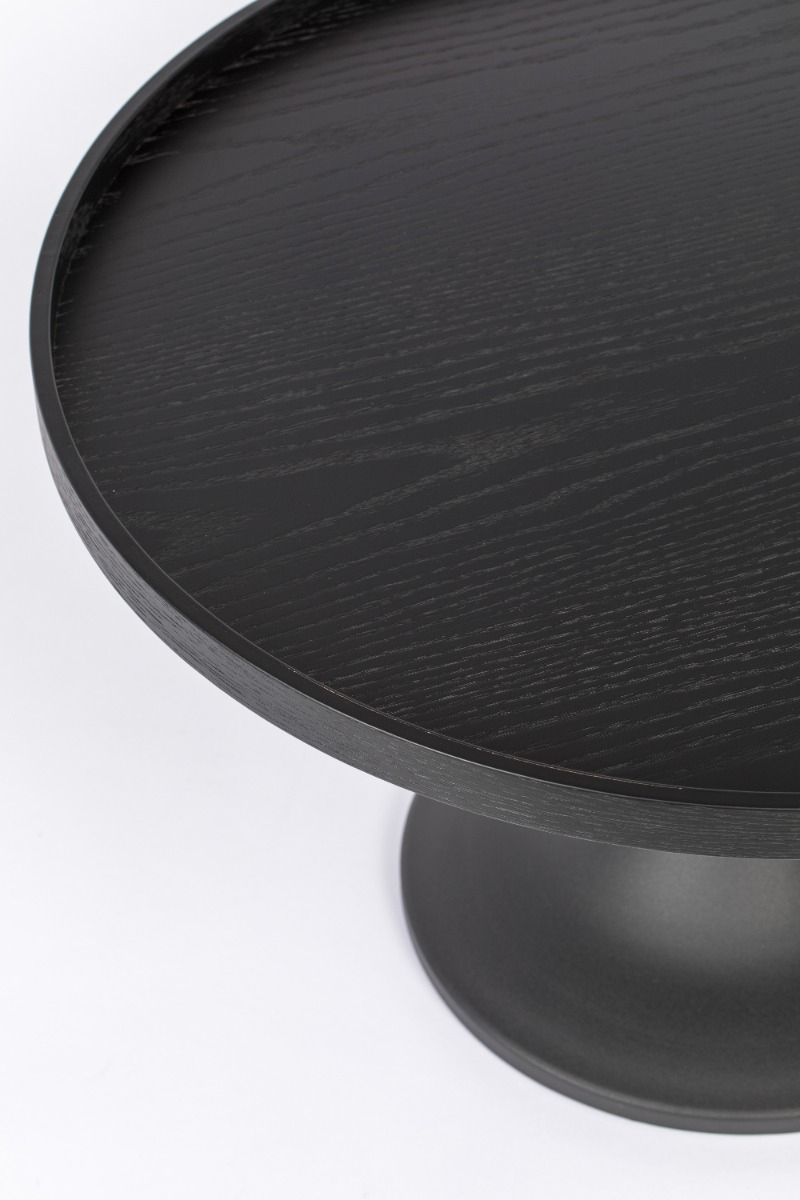 Close-up of the base and underside of a black round pedestal table with a circular base