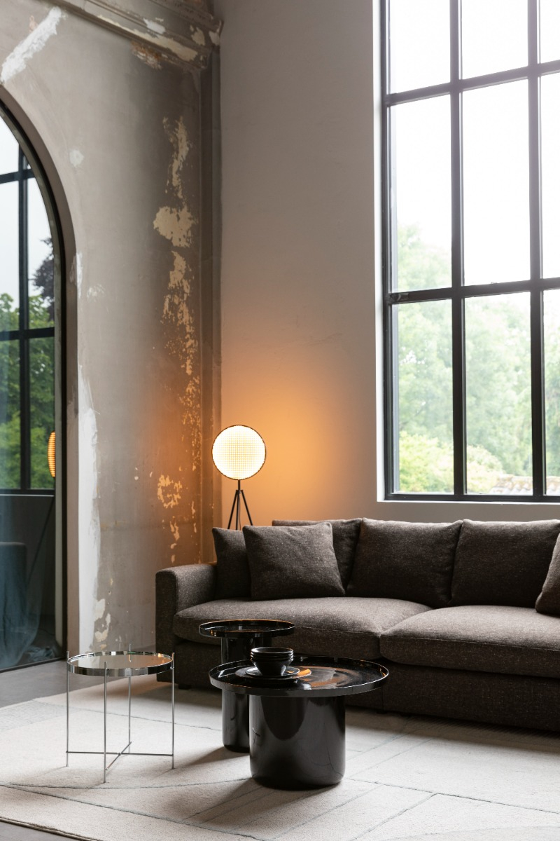 Close-up of armchair and side tables near window