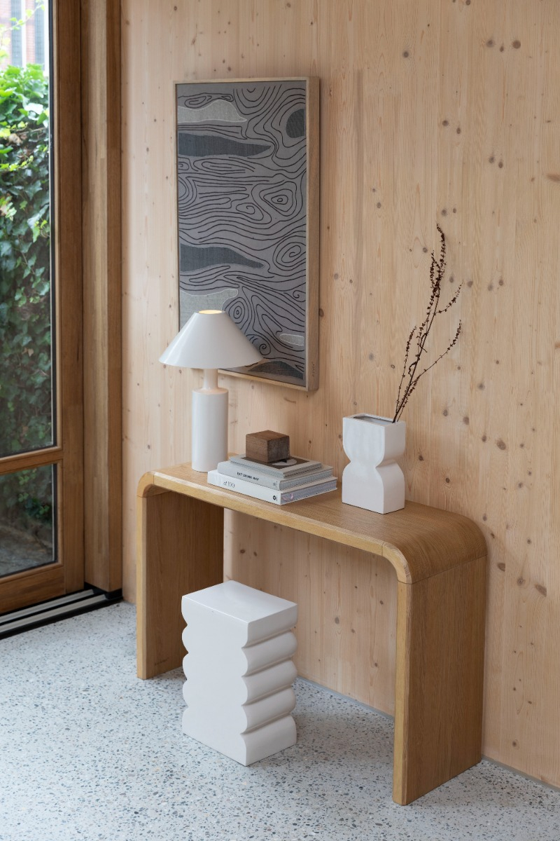 Angled view of a wooden bench with curved edges and legs